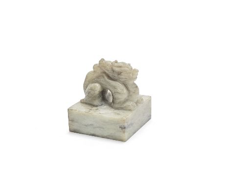 A pale and mushroom jade square 'dragon' seal20th centuryCarved from a creamy, pale stone with streaked brown and mushroom in