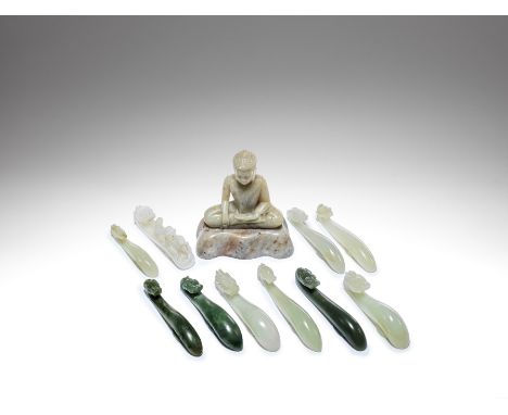 A small collection of jade belt hooks and a jade figure of BuddhaQing Dynasty Comprising nine variously spinach and pale gree
