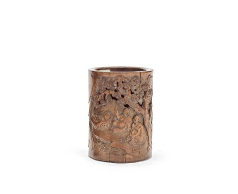 A reticulated bamboo brushpot18th centuryCarved in openwork relief with a gathering of gentlemen in a clearing, seated beside