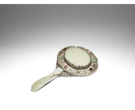 A pale green jade-mounted and embellished silver hand mirrorLate Qing DynastyA jade 'chilong' belt hook forming the handle, t