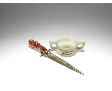 A jade two-handled cup and a mounted jadeite belt hookMing Dynasty and laterThe cup of pale green jade, carved to the exterio