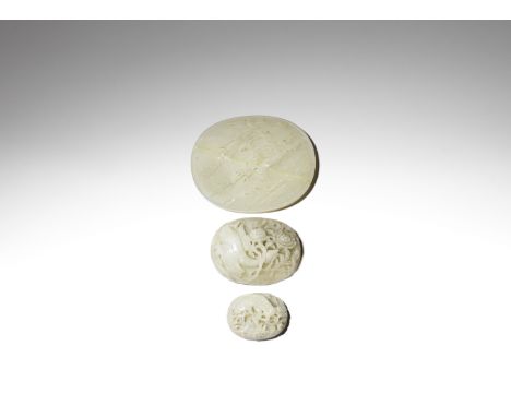 Three pale green jade ruyi plaquesQing DynastyThe largest carved with a phoenix perched on the branch of a blossoming prunus 
