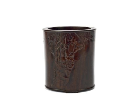 A carved Zitan brushpotWith beaded edges, standing on three, short, bracket feet, carved in shallow relief to one side with a
