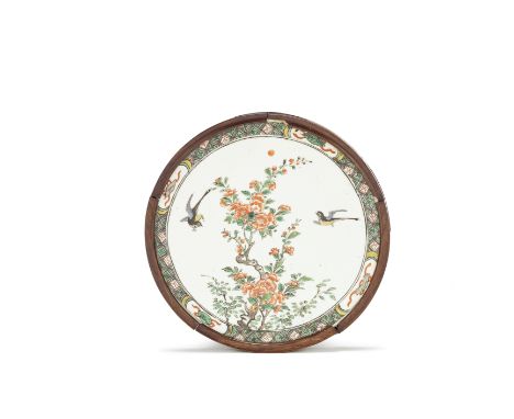 A famille verte circular plaqueKangxiDecorated with two birds amongst blossoming leafy branches, within a border of auspiciou
