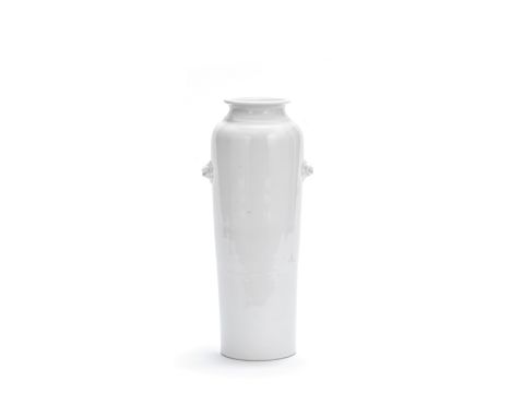 A blanc-de-Chine tapering cylindrical vase17th/18th centuryWith moulded lion mask handles and flaring neck, incised two-line 