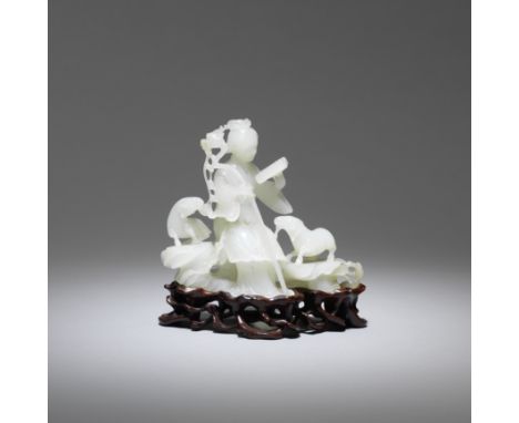 A white jade figure of a lady and two ramsThe pale, even stone with some speckled dark and a mushroom inclusion, delicately c