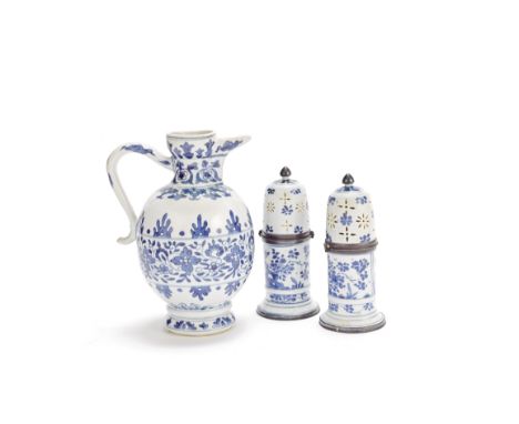 A blue and white 'floral' jug and a pair of white metal-mounted blue and white sugar castersThe porcelain KangxiThe jug of ov