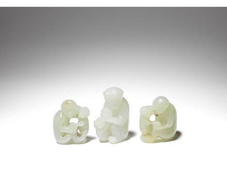 A group of three pale jade 'monkey' carvings19th/20th centuryComprising: a white jade carving of a monkey embracing its infan