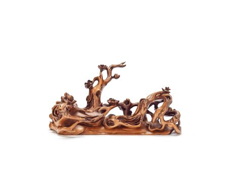 A boxwood 'gnarled prunus' brush restQing DynastyIntricately carved as a twisted and gnarled trunk issuing prunus blossom. 18