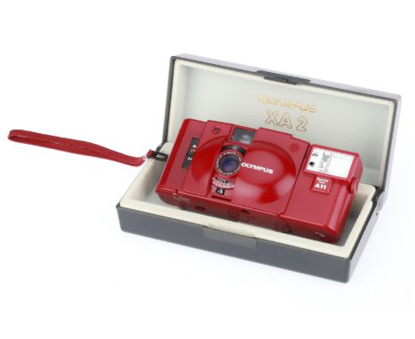 red, body VG, shutter works, metering responds to light, A11 flash works, in presentation case, also VG.