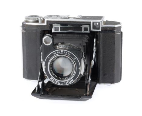 black, serial number VK421, shutter working, speeds a little slow longer than ¼ second, has the f/2.8 8cm Tessar lens, optics