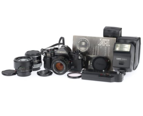 comprising a Canon A-1, black, serial number 1079245, body VG, shutter works, has a minor squeak, metering responds to light,