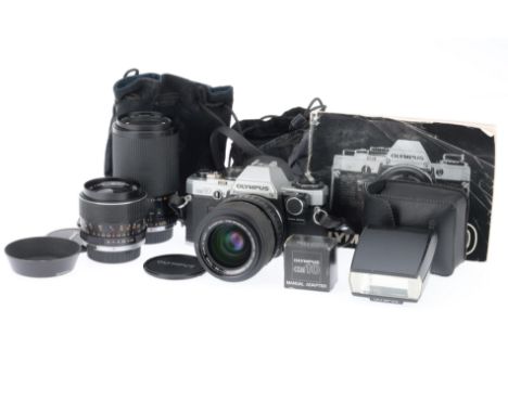 comprising OM-10 serial number 881161, body G, usage marks to base, shutter works, metering appears to work, with manual adap