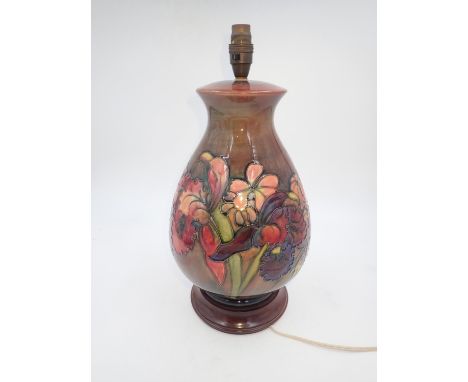 Large Moorcroft flambe lamp in the Orchid pattern. All electrical items in this lot have been PAT tested for safety and have 