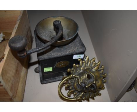 A large cast Victorian coffee grinder and a large brass door knocker