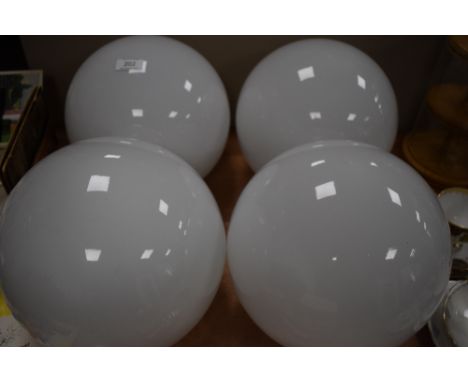A set of four vintage milk glass globular light shades