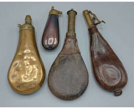 An early leather shot flask together with another similar and two metal powder flasks 