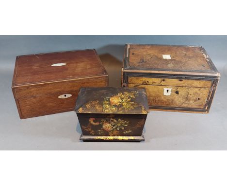 A Victorian black lacquered tea caddy decorated with flowers together with two work boxes 