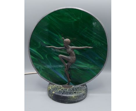 An Art Deco style table lamp mounted with a dancing lady and with a circular mottled glass shade upon a circular base, 31cms 