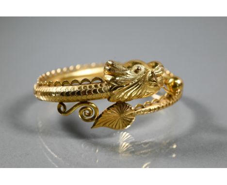 A Chinese yellow gold half-hinged bangle in the form of a coiled dragon chasing the flaming pearl, the body naturalistically 