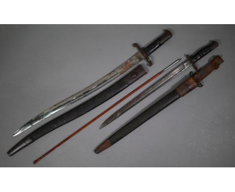 A World War I Remington P14 bayonet with 43 cm fullered blade and two-piece notched wood hilt, in metal-mounted leather scabb