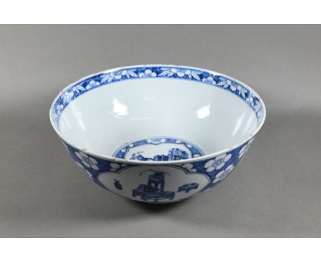 A Chinese blue and white bowl, the exterior painted with scholars studio interiors and figures in garden landscapes within al