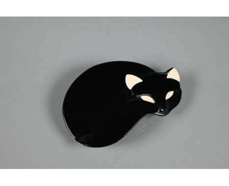 Lea Stein, Paris - A brooch modelled as a curled-up black cat with cream eyes and ears, stamped to brooch fitting, 7 x 5 cm 