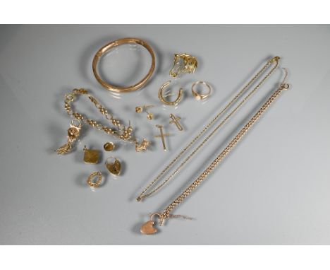 A quantity of 9ct yellow gold including horseshoe brooch, curb bracelet with padlock attached, pendants, charms, ring, bangle