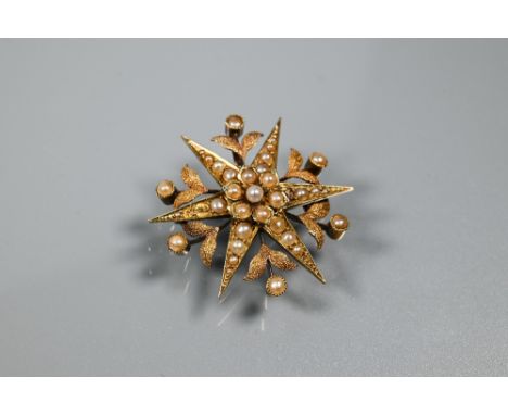 A Victorian star burst brooch, set overall with seed pearls, 15ct yellow gold set, approx 5.8g all in, 3.5 cm diam 