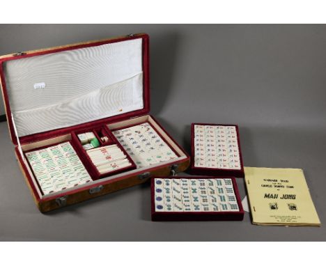 A vintage Chinese velvet cased Mah-Jong set with bone and bamboo tiles including three complete suits (stones, bamboo and cha
