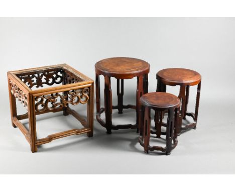 A late 19th or early 20th century Chinese square stand (lacking top panel) with carved and pierced dragon frieze on moulded s