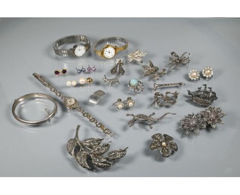 A collection of marcasite and white metal jewellery items including brooches, bangle, wristwatches etc 
