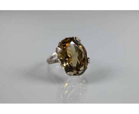 A large oval smokey quartz ring, claw set with silver trellis mount, size O, 2 x 1.5 cm 
