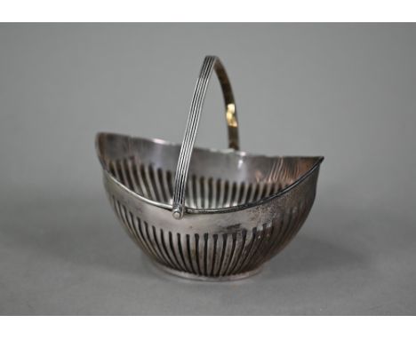 An Edwardian silver sugar basin of half-reeded elliptical form with swing handle, Barker Brother, Birmingham 1905, 3.3oz, 12.