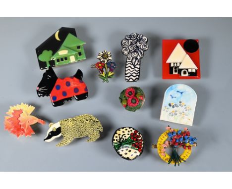 A selection of vintage and later clay, wood and cellulose/acetate brooches modelled as Scotty dog, houses by Lucinda, etc (10