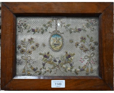 A pair of early 19th century embroidered panels, worked with central oval medallions depicting doves and baskets of flowers, 