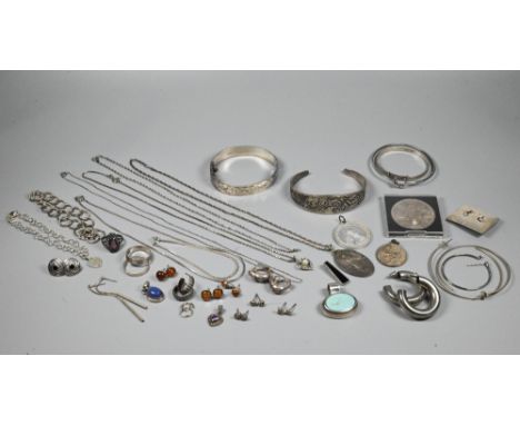 A small collection of silver and white metal jewellery including oval half-hinged bangle, pendants, chains, earrings, etc 