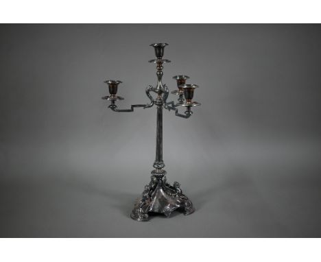 A large Victorian electroplated three-branch candelabrum with four sconces raised on a reeded pillar, the triform base mounte