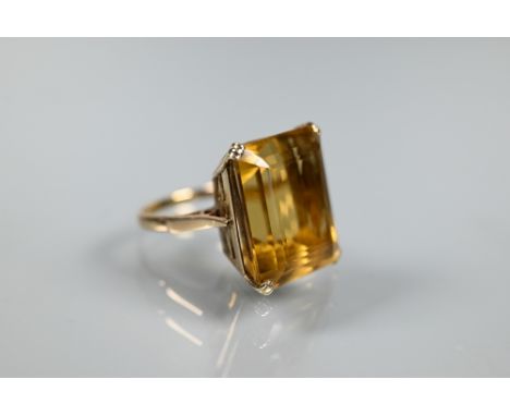 A rectangular citrine cocktail ring, yellow metal indistincly stamped, claw set with decorative mount, size O 