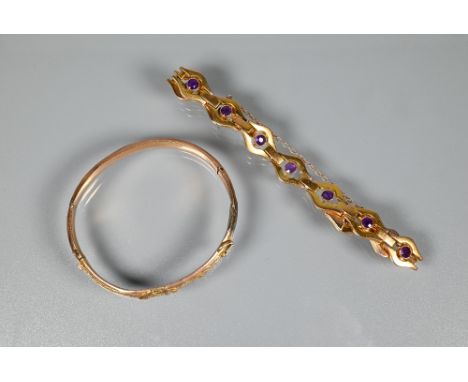 A yellow metal bracelet stamped 9ct formed of open links with bezel set amethysts to the centre of each link, concealed clasp