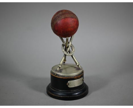 Cricket: an EPNS trophy modelled as three wreathed stumps to support a leather cricket ball, an ebonised plinth with engraved