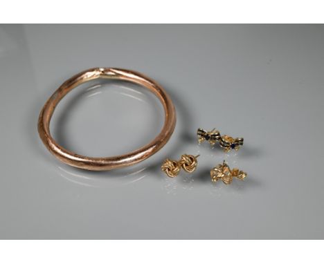 A collection of various 9ct gold earrings including knot studs, bows set with sapphires and diamonds, etc and a hollow linked
