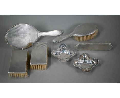 Four engine-turned silver hairbrushes and a hand-mirror, Birmingham 1957, to/w two quatrefoil pin-dishes (a/f) 