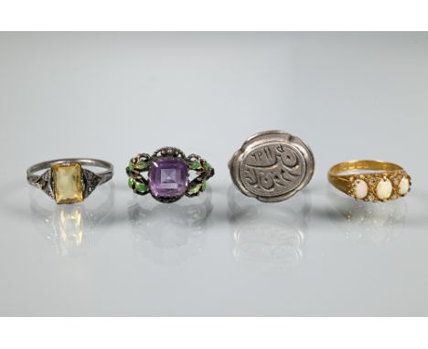 An antique 18ct yellow gold ring set with three graduated opals with rose cut diamonds, size L to/w purple paste and green en