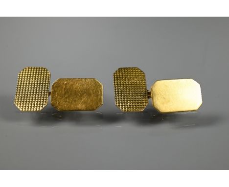 A pair of 18ct yellow gold chain-link cufflinks of rectangular form with canted corners, one side with engine turned decorati