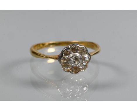 An antique diamond cluster ring, the central old cut diamond with eight old cut diamonds around, 18 ct yellow gold set, size 