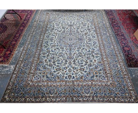 AMENDED ESTIMATE A Persian Kashan carpet, the pale jade green ground with floral deign, centred by a medallion, 390 cm x 290 