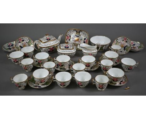 An early 19th century Swansea china part tea service, painted and gilded with floral design, comprising teapot on stand, suga