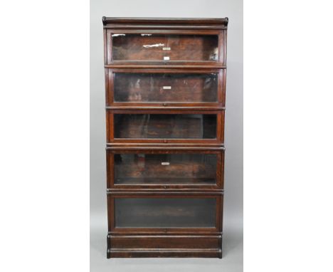 A dark oak five section Globe Wernicke library bookcase, with glazed-in hinge-over doors, on a plinth base, 86 cm w x 32 cm x