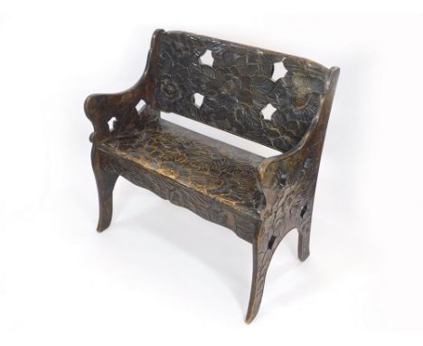 CARVED SEAT. An early 20th century seat, with all-over carved lotus blossom decoration. H91xW91xD47cm.   Please note that all